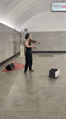 Violin busking in a Moscow metro station, July morning