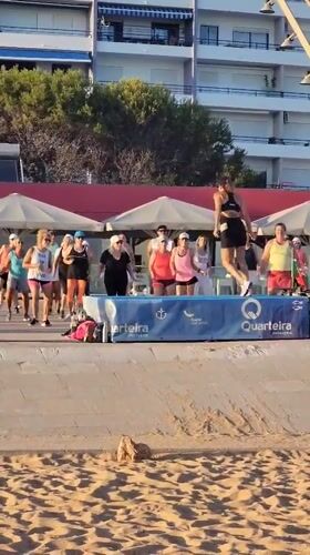 Beachside fitness class on a raised platform in Quarteira
