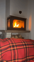 Couple relaxes by fireplace in Bansko during early morning