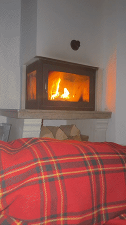 Couple relaxes by fireplace in Bansko during early morning