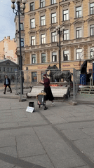 Female flutist busks in Saint Petersburg public square