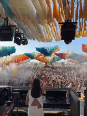 Female DJ performs at daytime music festival in Indio
