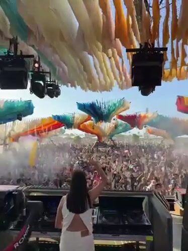 Female DJ performs at daytime music festival in Indio