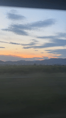 Sunset landscape captured from vehicle window near Sagunto, Spain