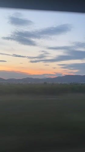 Sunset landscape captured from vehicle window near Sagunto, Spain