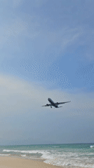 Commercial aircraft makes routine landing approach over Cam Ranh beach