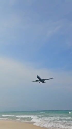 Commercial aircraft makes routine landing approach over Cam Ranh beach