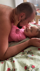 Father shares tender moment with toddler in Wisła bedroom