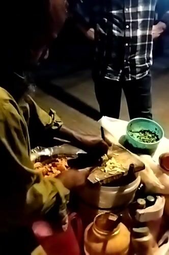 Street vendor prepares traditional food in Dhaka