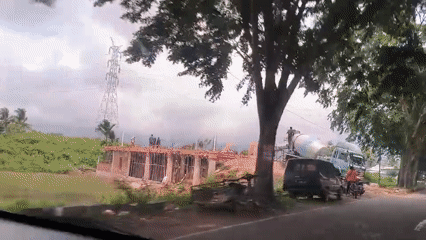 Construction activity observed on tree-lined Indonesian road
