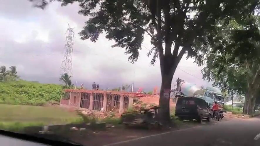 Construction activity observed on tree-lined Indonesian road