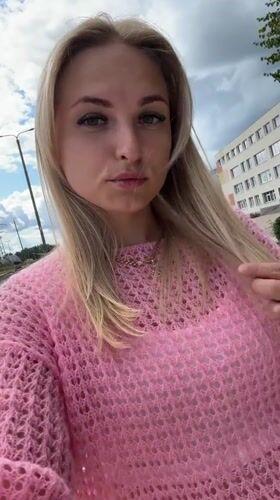 Outdoor selfie session, pink knit sweater, cloudy sky backdrop