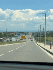 Highway journey near Sofia captures mountain tower views, traffic