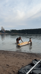 Shoreline paddleboard session with kids in shallow water