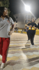 Young women dance in public plaza in Tacna, Peru