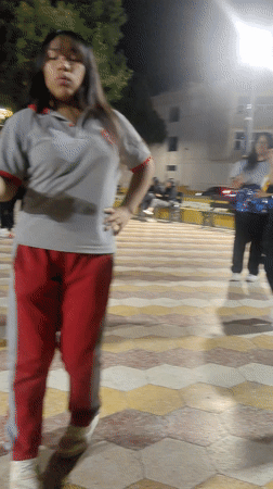 Young women dance in public plaza in Tacna, Peru