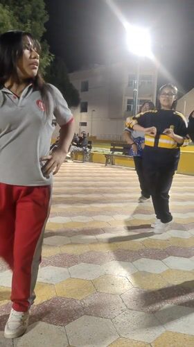 Young women dance in public plaza in Tacna, Peru