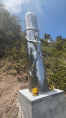 Reflective metallic humanoid sculpture spotted in Thai village
