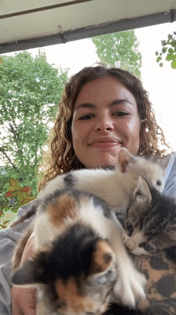 Woman photographed with kittens in Danilovgrad, Montenegro