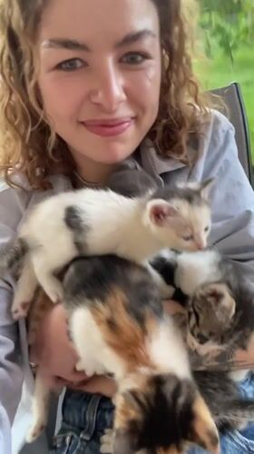 Woman photographed with kittens in Danilovgrad, Montenegro