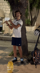 Flute playing, street cats, and a resting dog in Makarska