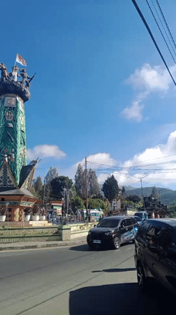 Hanging out at a Berastagi café by the town monument