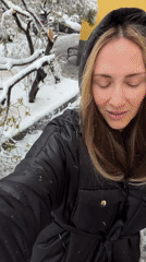 Woman walks through snowy Moscow streets during morning snowfall