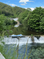 Tourist documents Rudozem waterfall and bronze goat sculpture