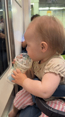 Infant in striped pants observed in baby carrier