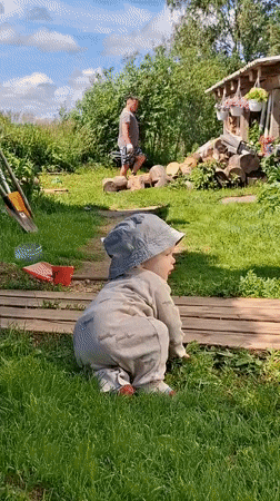 Summer day at a Russian rural homestead: kids, animals, and firewood