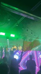 Late-night club event with DJ and fog lights in Howayi