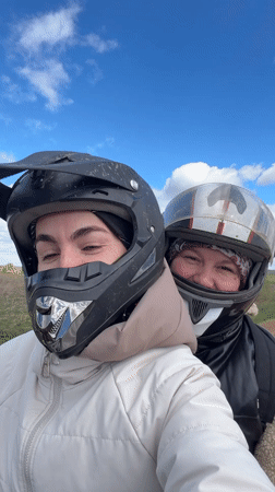 Two women ride ATV in Russian countryside