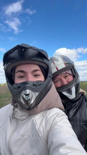 Two women ride ATV in Russian countryside