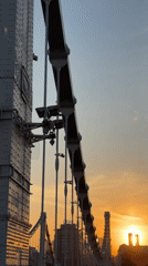 Metal bridge captured against sunset sky by witness