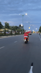 Scooter passengers travel bridge road in Phu Thuy Ward