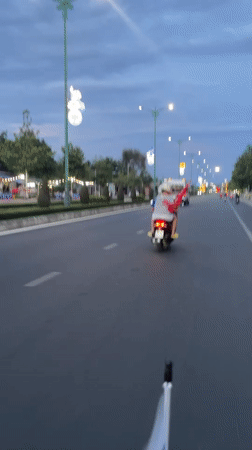 Scooter passengers travel bridge road in Phu Thuy Ward