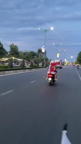 Scooter passengers travel bridge road in Phu Thuy Ward