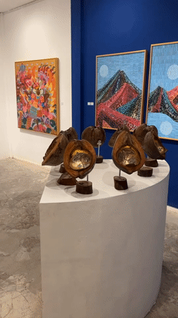 Woman visits art gallery showcasing Balinese paintings in Ubud