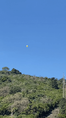 Yellow balloon spotted over Budva hills, torn paper bag documented