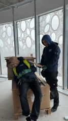 HVAC workers take break on equipment boxes in Sofia construction site