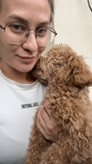 Woman shares affectionate moment with curly-haired dog in Russia