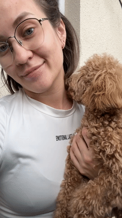 Woman shares affectionate moment with curly-haired dog in Russia