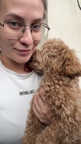 Woman shares affectionate moment with curly-haired dog in Russia
