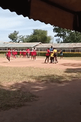 Outdoor volleyball match between red and yellow teams in Kenya