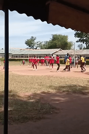 Outdoor volleyball match between red and yellow teams in Kenya