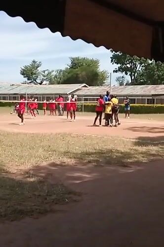 Outdoor volleyball match between red and yellow teams in Kenya