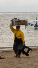 Beach vendors serve customers despite warning flags in Denpasar