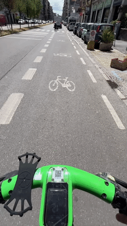 Electric scooter rider documents Milan bike lane journey