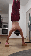 Man performs handstand in pajamas at Burgas home