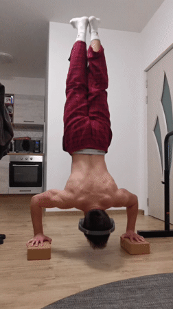 Man performs handstand in pajamas at Burgas home